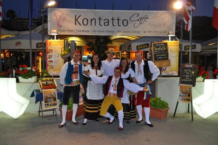 The costumed group posing in front of a harbour-side bar before an evening show